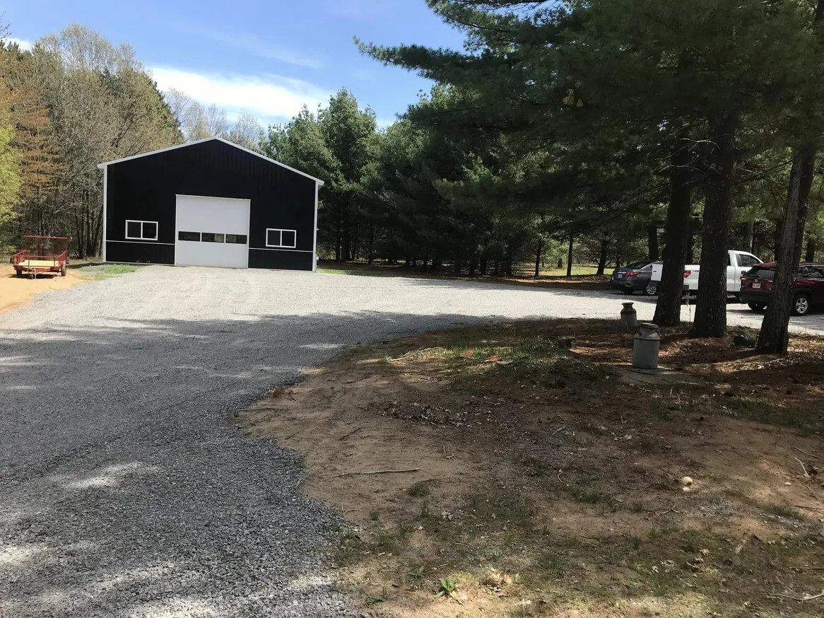 Finished gravel drive and turnaround in front of a pole barn, gravel driveways