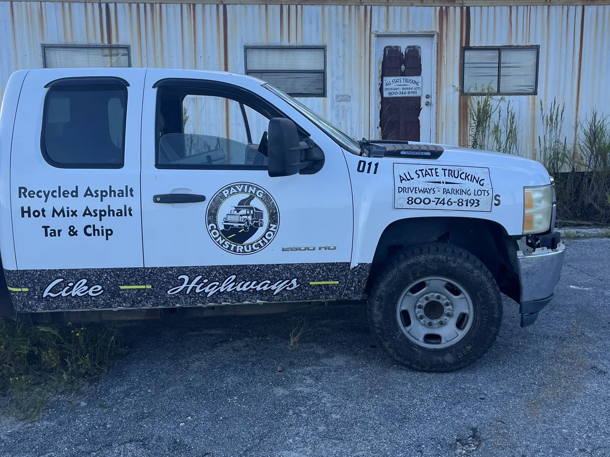 Company pickup lettered for recycled asphalt, hot mix asphalt and tar and chip paving