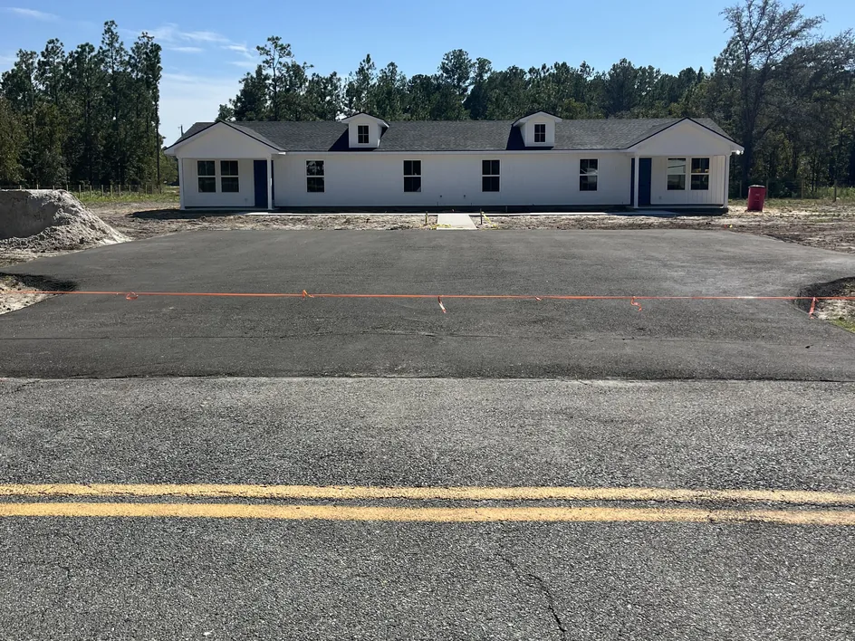 Recycled asphalt parking pad in front of a new duplex, parking lot paving
